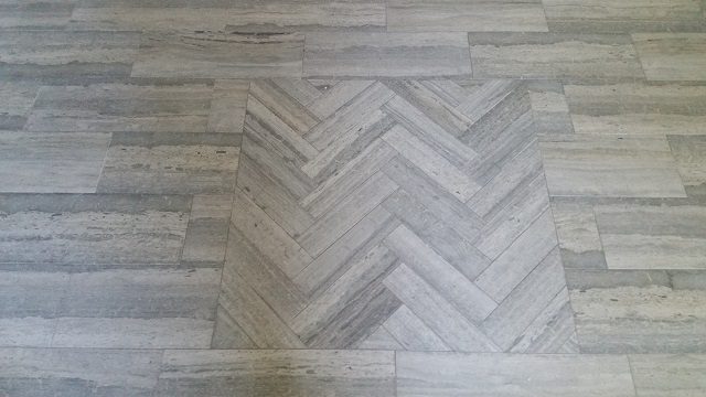 A white floor with some wood like patterns