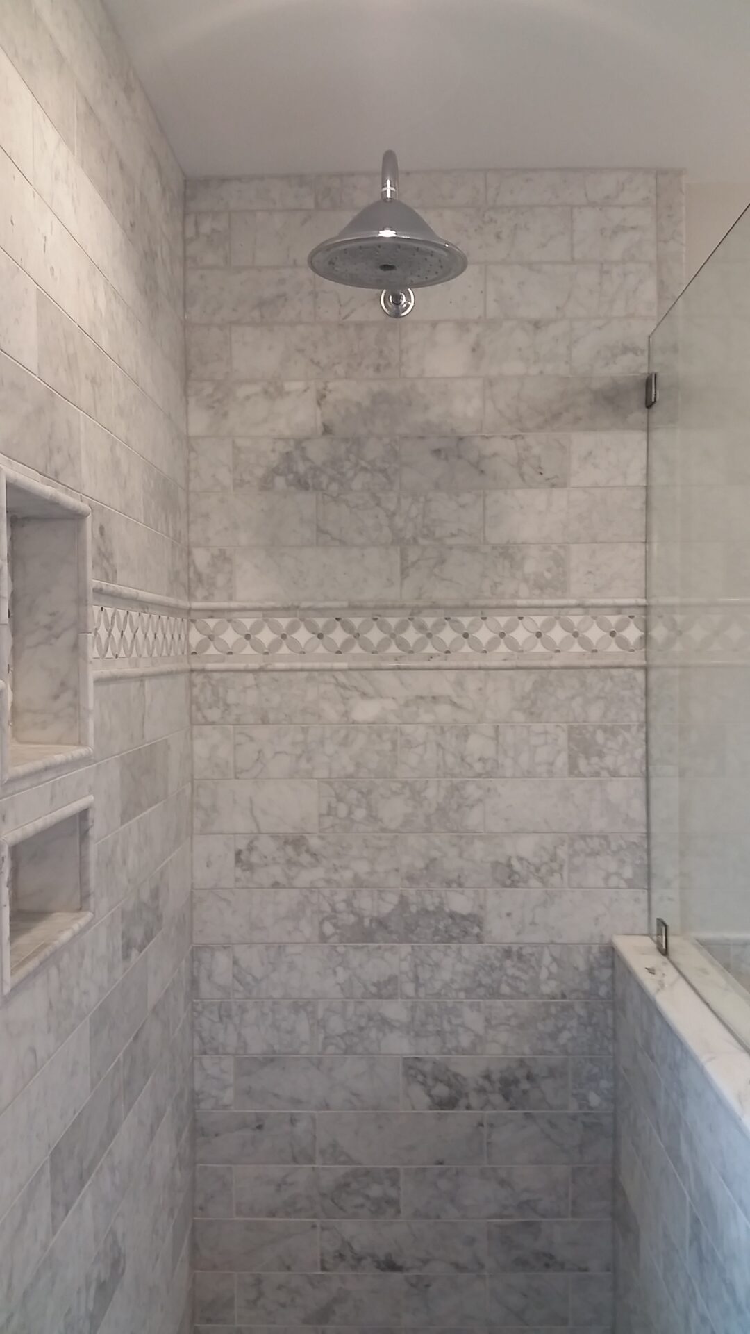 A bathroom with marble walls and floors